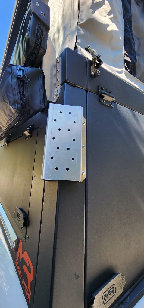 Metal roof rack mounted on a vehicle with visible branding.