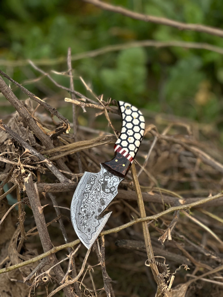 Decorative knife with a unique handle design on dry grass