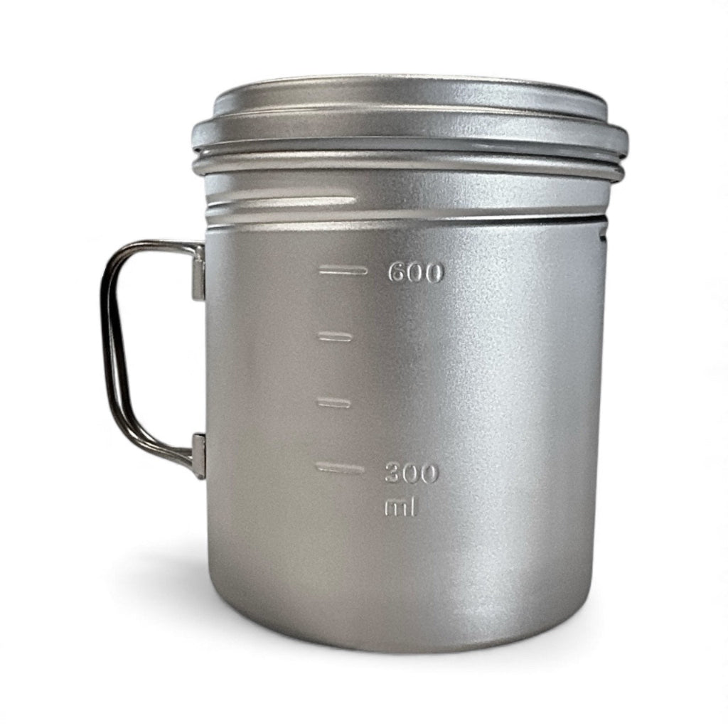 Silver camping mug with handle and measurement markings on a white background