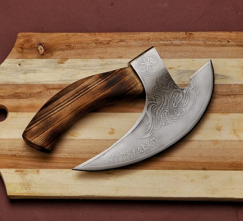 Decorative knife with wooden handle on a wooden surface