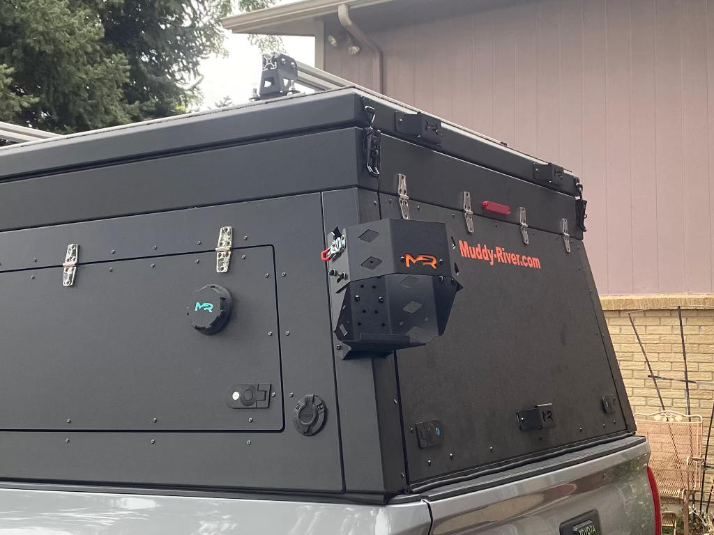 Roof box on a vehicle with 'Muddy River' branding