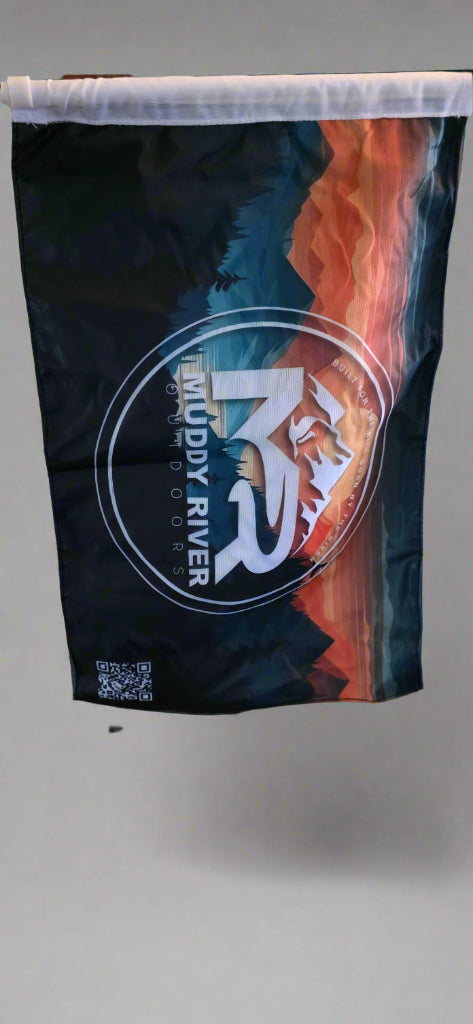 Muddy River flag displaying the Muddy River Outdoors logo with mountain and sunset design hanging vertically.