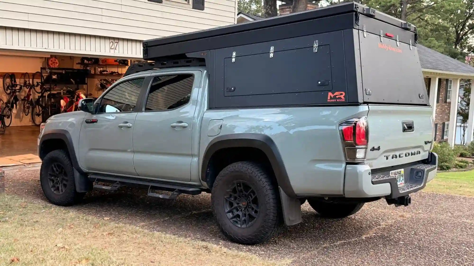 Lightweight truck bed campers installed on a Toyota Tacoma, showing a low-profile wedge camper design ideal for off-road travel and everyday driving