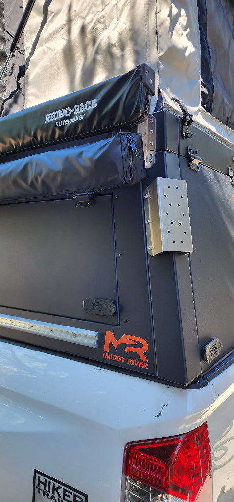Car roof rack system on a white vehicle with visible branding