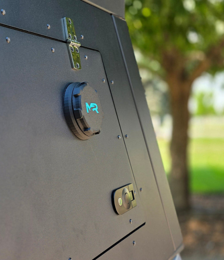 Diesel / Propex heater port with protective cap attached to an overland truck camper side panel.