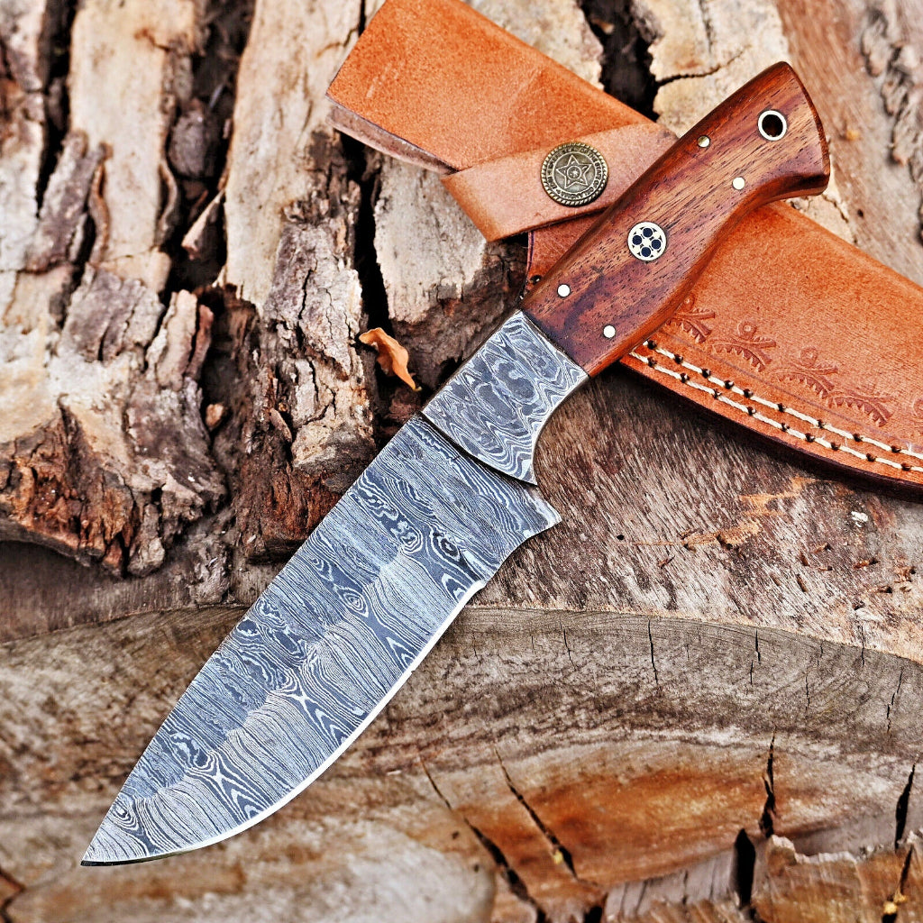 Decorative knife with a wooden handle and leather sheath on a wooden surface