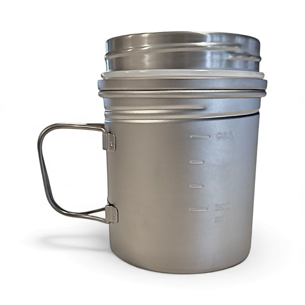 Stainless steel mug with handle on a white background
