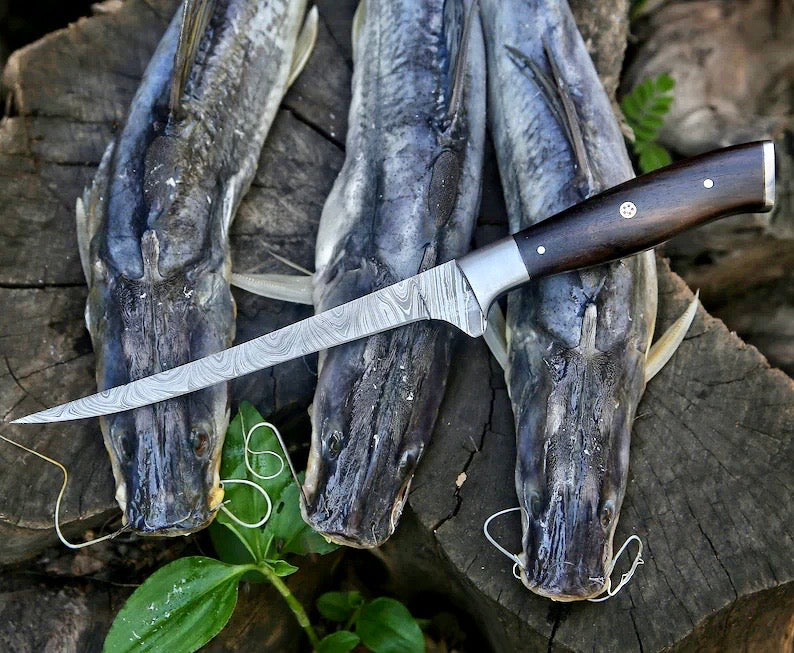 Fishing knife on a wooden surface with fish heads