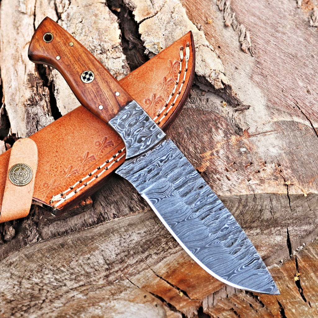 Decorative knife with a wooden handle and leather sheath on a wooden background