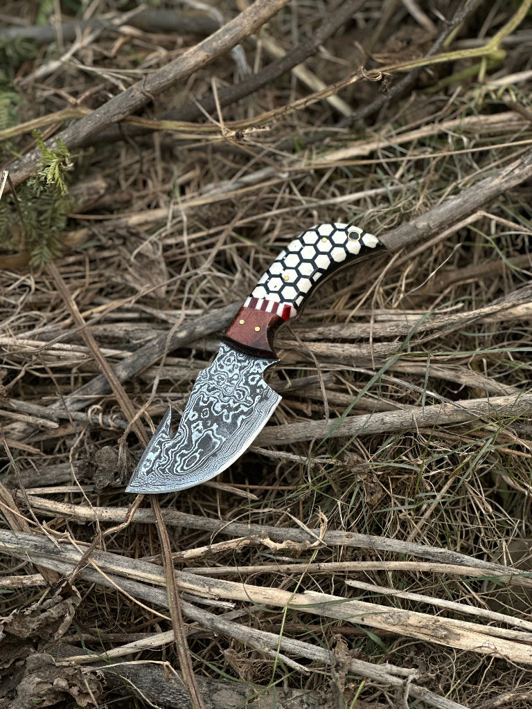Decorative knife with a unique handle design on dry grass
