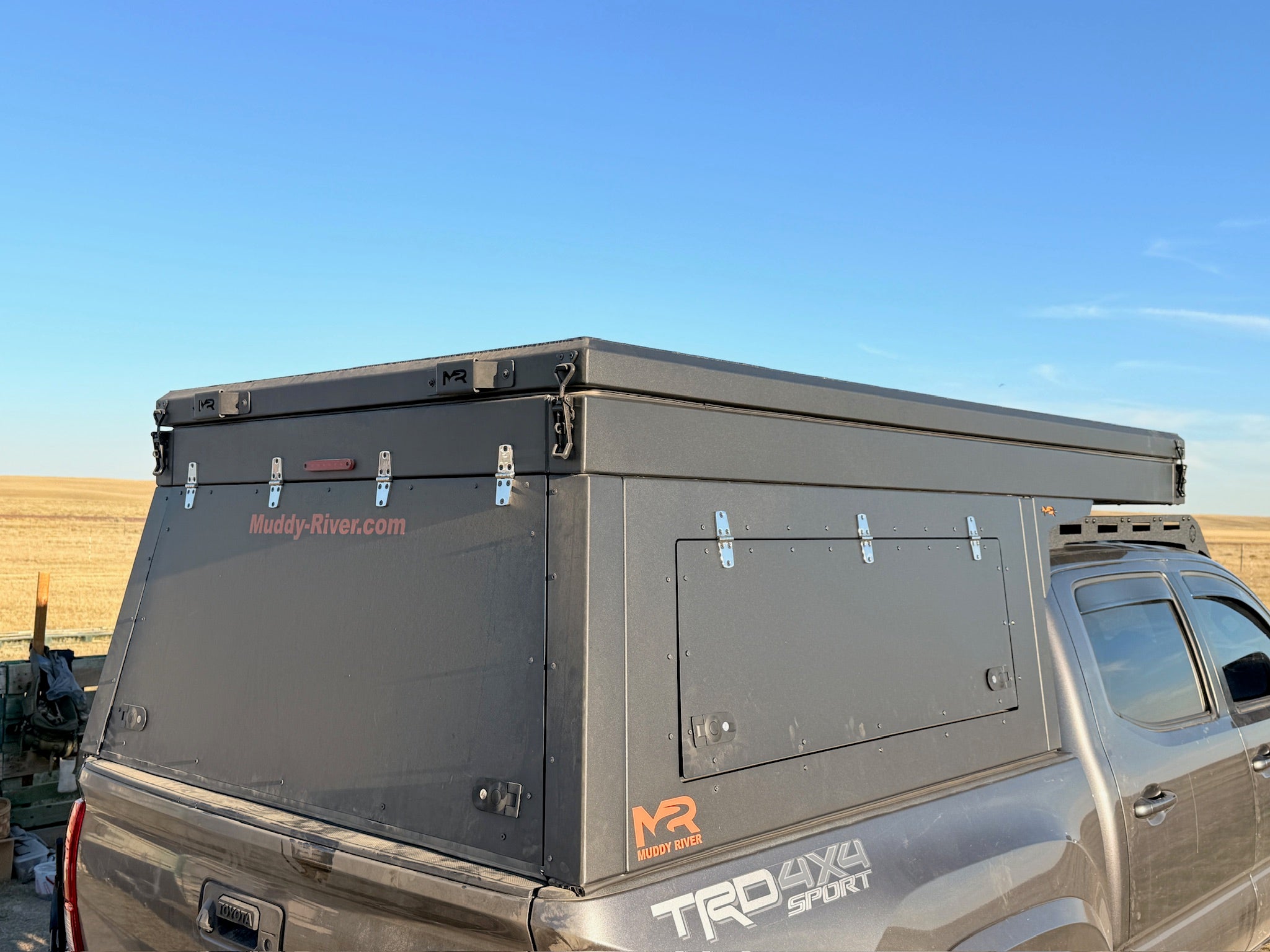 Roof storage box on a truck bed with a clear blue sky background